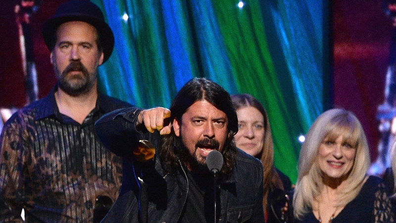 Nirvana's Krist Novoselic (l) and Dave Grohl (c) were joined by Kurt Cobain's sister, Kimberly Cobain, and mother, Wendy O'Connor onstage