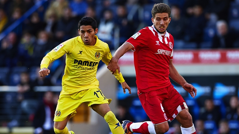 Aquino (L) of Villarreal competes with Daniel Carrico of Sevilla during a La Liga match last December