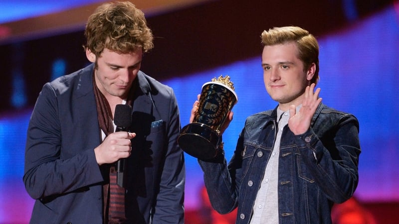 The Hunger Games: Catching Fire stars Sam Claflin and Josh Hutcherson accepting the Movie of the Year award