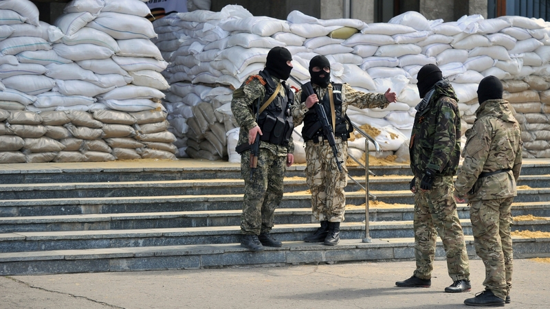 Armed men guard a regional state building seized by the separatists in the eastern Ukrainian city of Slavyansk