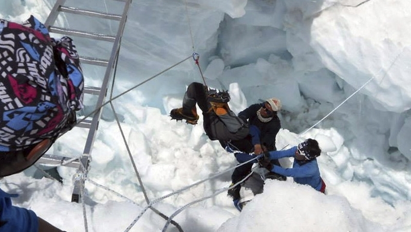 Mountain rescue workers lift an injured climber after the avalanche hit