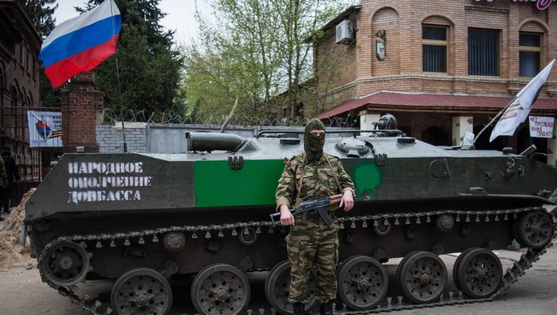 An armed pro-Russian protester stands in front of an occupied police station in Slaviansk, Ukraine