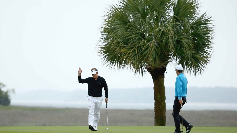Luke Donald acknowledges the gallery as Scott Langley looks on