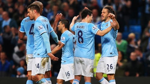 City players celebrate with Martin Demichelis after he scored the third at the Etihad Stadium