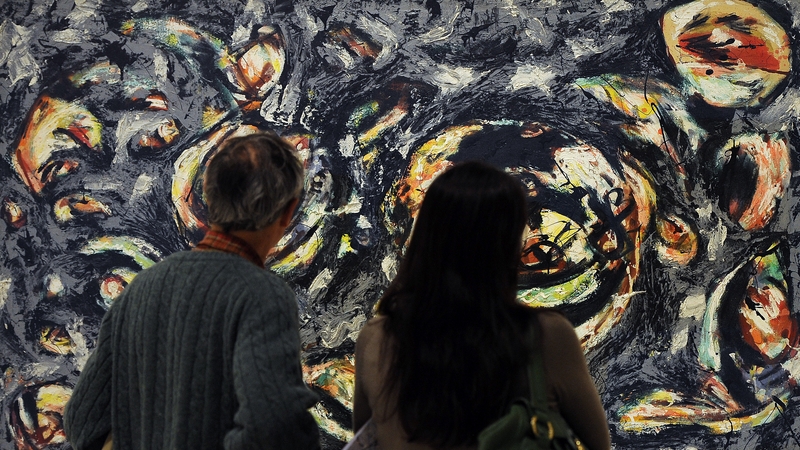 Visitors look at an authentic untitled work by US artist Jackson Pollock belonging to the Guggenheim foundation