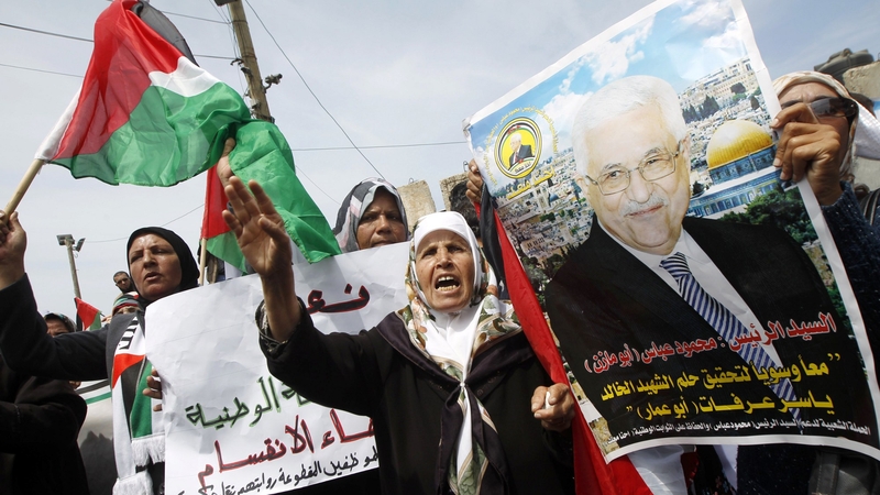 Palestinians hold a portrait of Mahmoud Abbas as they take part in demonstrations in support of a new attempt to reconcile with Hamas