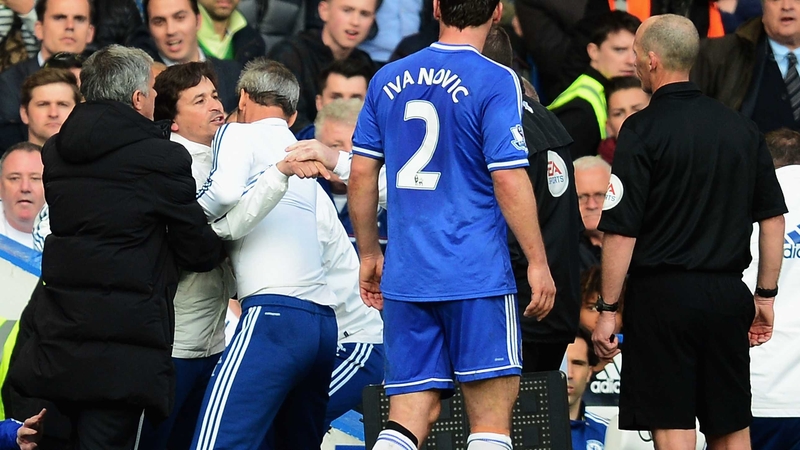 Chelsea coach Rui Faria is held back by Jose Mourinho as he confronts match referee Mike Dean