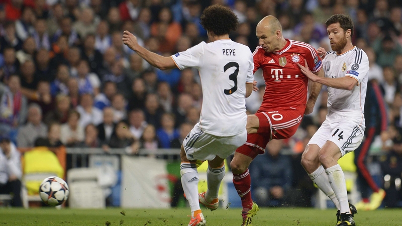 Arjen Robben tries to get a shot away under pressure from Madrid pair Pepe and Javi Alonso