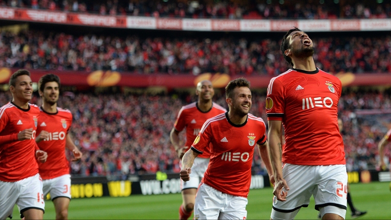 Benfica players rush to celebrate with goal scorer Ezequiel Garay