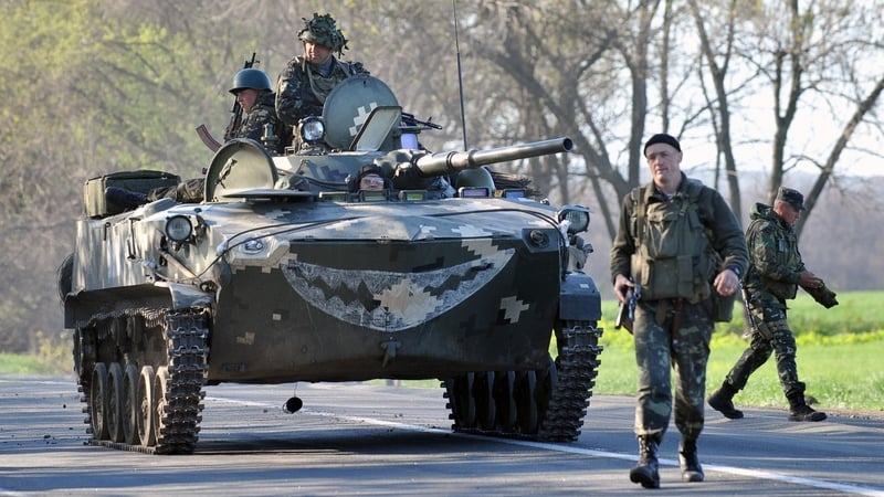 Ukrainian soldiers stand guard at a new checkpoint near Slaviansk