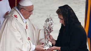 Floribeth Mora, who claims she was cured of a serious brain condition by a miracle attributed to late Pope John Paul II, presents his relic to Pope Francis