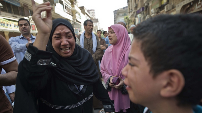 Egyptians react outside the courtroom in Minya after the death sentences were announced