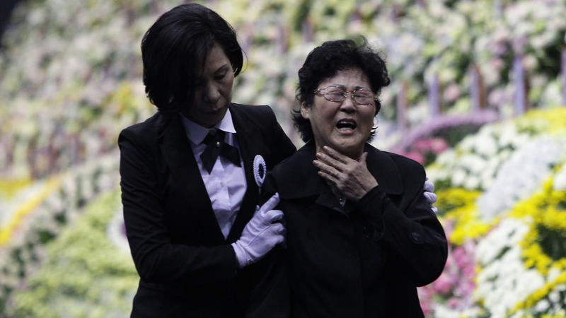 A woman weeps at a group memorial altar for victims of the sunken ferry