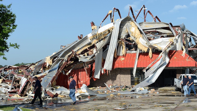 Insurance adjustors inspect what is left of the Fleet Pride Truck & Trailer Parts building in Richland, Mississippi