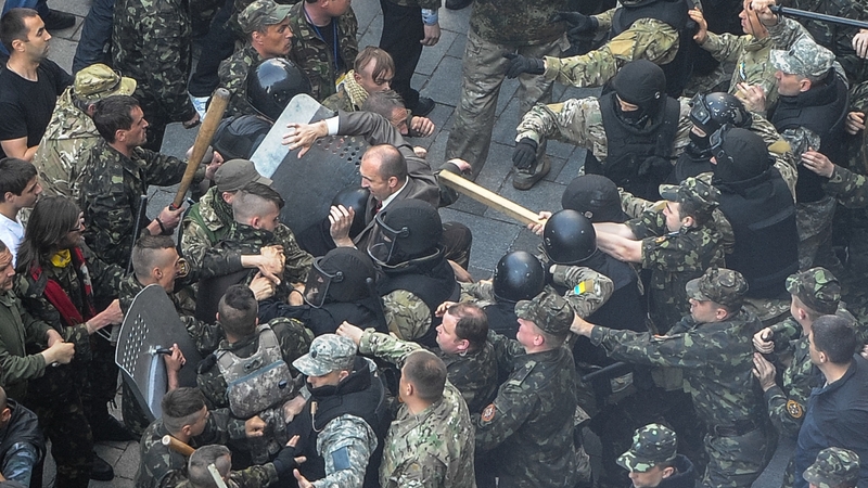 Ukrainian Maidan self-defence activists clash with special police, who are guarding the Cabinet of the Ministers building in Kiev