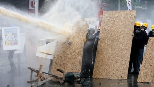 Turkish riot police use water cannon and tear gas to disperse protesters during a rally for May Day in Istanbul