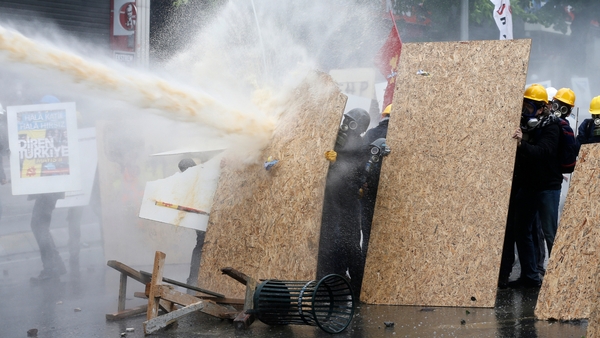 Turkish riot police use water cannon and tear gas to disperse protesters during a rally for May Day in Istanbul