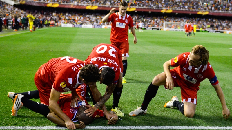 Stephane Mbia is mobbed by team-mates after grabbing an injury-time away goal