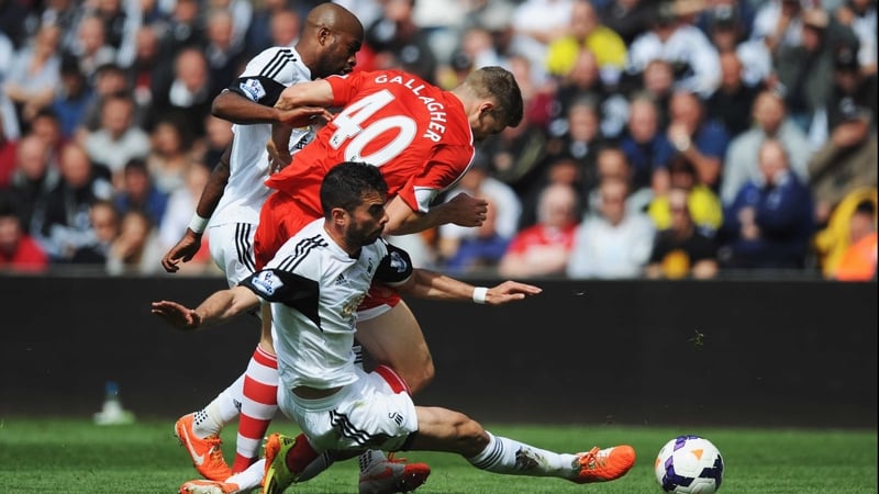 Sam Gallagher of Southampton is challenged by Dwight Tiendalli and Jordi Amat