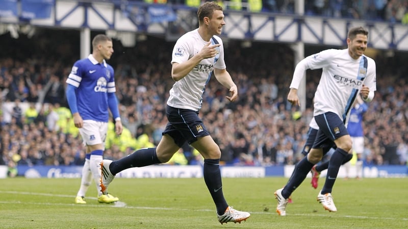 Manchester City's Edin Dzeko (C) celebrates scoring their third goal