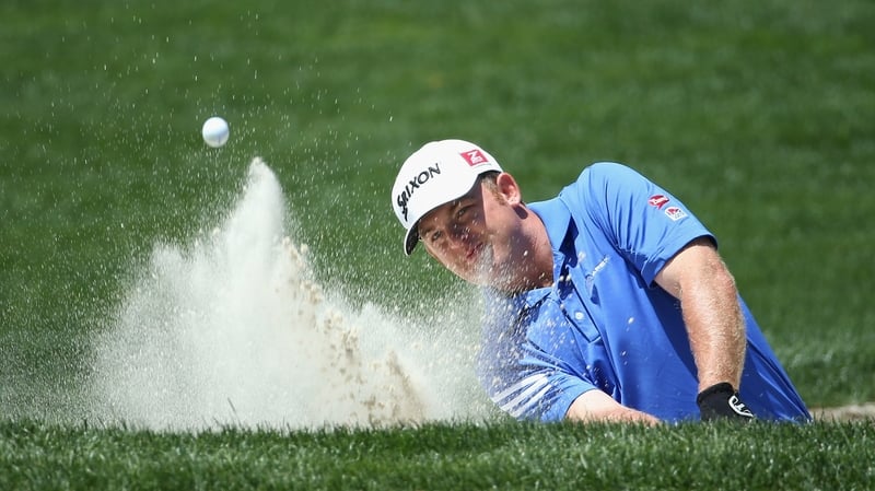 Holmes plays from a greenside bunker during the third round of the Wells Fargo Championship at Quail Hollow