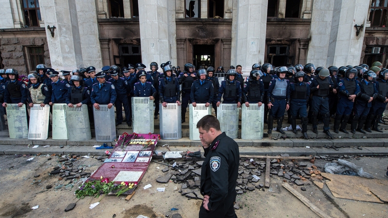 Policemen stand guard outside the charred trade union building in the southern Ukrainian city of Odessa