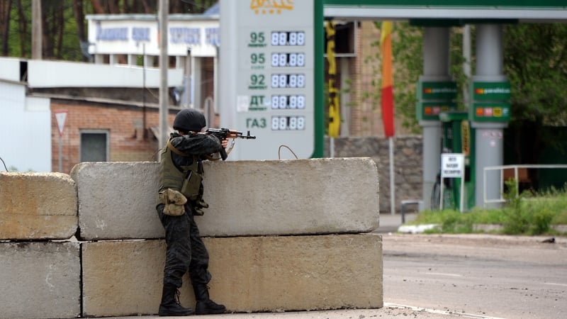 A Ukrainian soldier takes position at a checkpoint near the eastern Ukranian town of Slaviansk