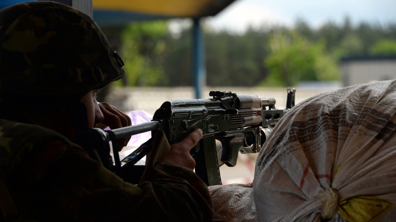 A Ukrainian soldier holds a position at a checkpoint near Slaviansk