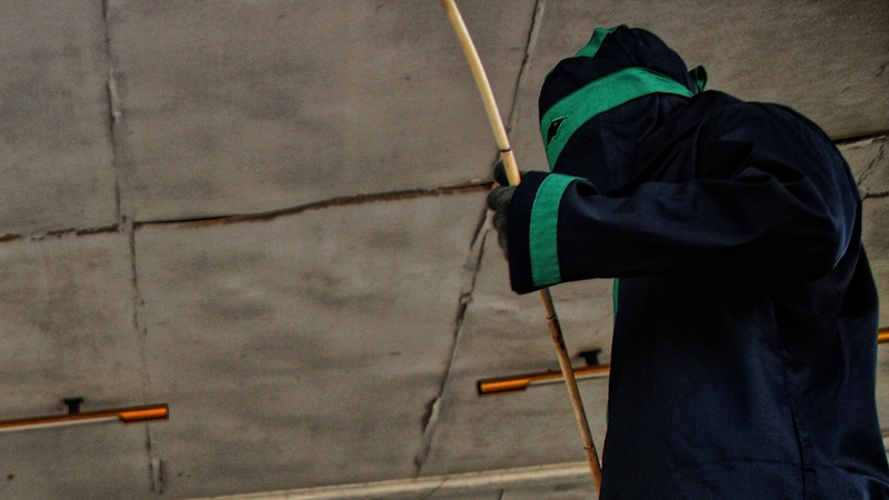 A sharia officer prepares to cane a man in Aceh
