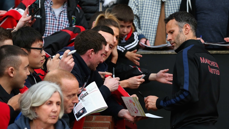 Manchester United caretaker manager Ryan Giggs signs autographs prior to the match