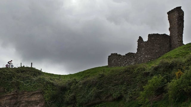 A cyclist rides along the Giro route at Red Bay Castle, Co Antrim