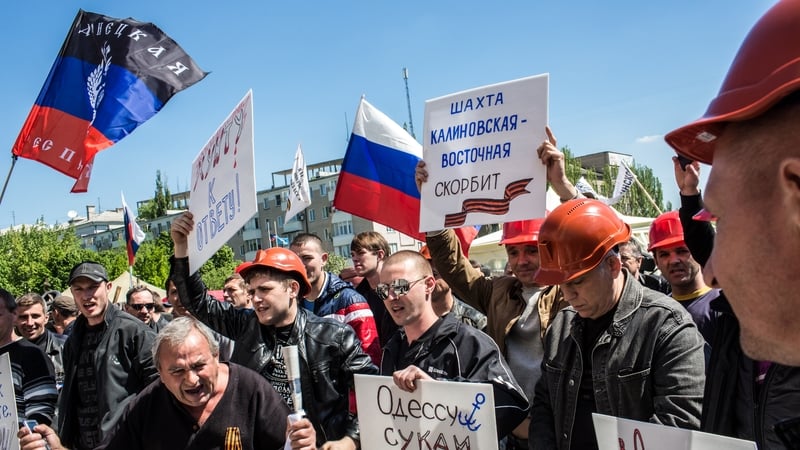 A group of miners rally in front of a regional administrative building occupied by pro-Russian supporters in Donetsk