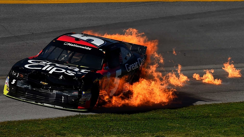 Flames are seen from the car of Kasey Kahne at the NASCAR Nationwide Series at Talladega Superspeedway