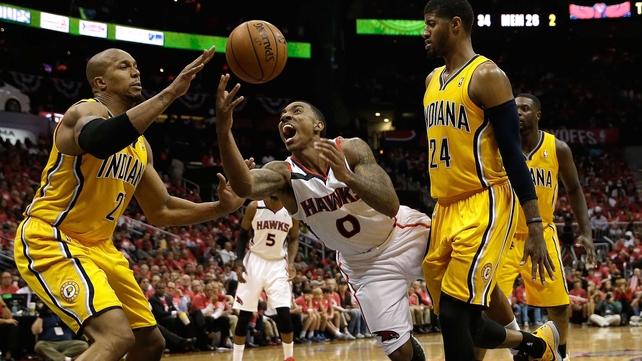Jeff Teague of the Atlanta Hawks is fouled by the Indiana Pacers defence