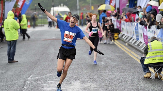 A runner shows his delight at the finish of the Belfast City Marathon