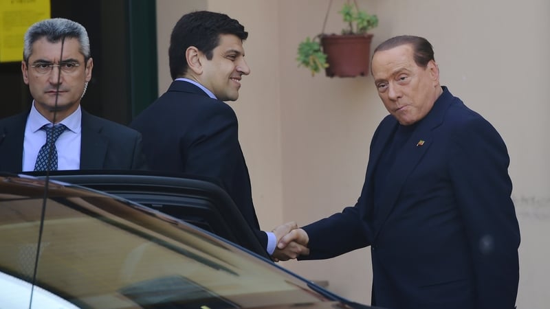 Silvio Berlusconi (R) arrives at the Catholic hospice 'Sacra Famiglia'