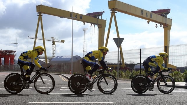 Members of the Tinkoff-Saxo team pass the Harland and Wolff cranes Samson and Goliath during a training session on Friday