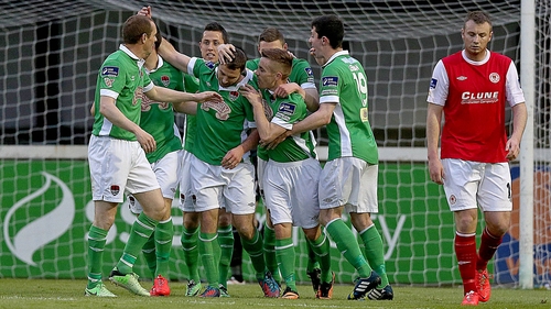 Mark O'Sullivan of Cork celebrates scoring the first goal with teammates as Kenny Browne of Pat's is dejected