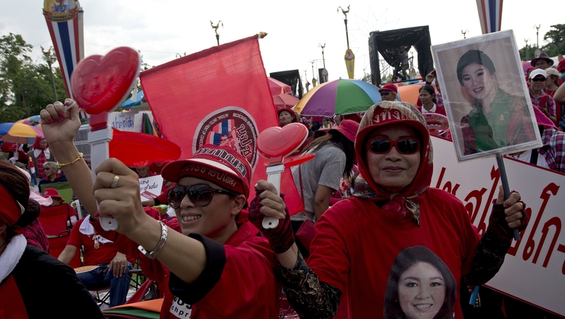 Thai pro-government 'Red Shirts' protesters hold portraits of ousted Thai prime minister Yingluck Shinawatra as they rally in Bangkok