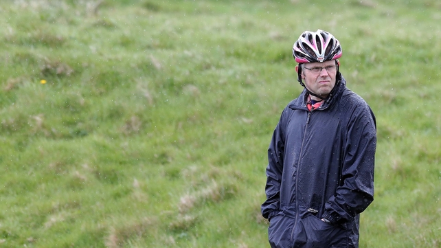 A particuarly careful spectator waits for the Giro riders to pass by Dunluce Castle on Saturday