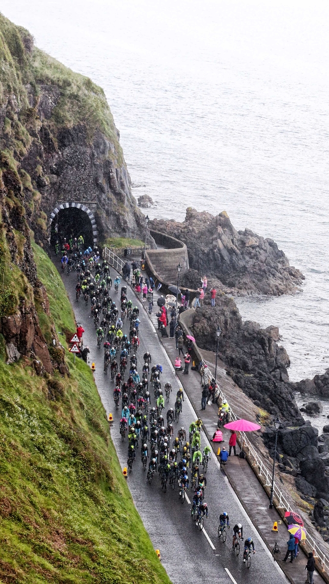 The Giro d'Italia Peloton makes its way along the County Antrim coast road at Drains Bay, Larne