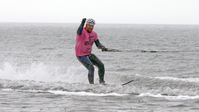 Cushendall man Marty McGarry follows the Giro d'Italia Peloton on a water-ski as it travels along the North Antrim Coast on Saturday