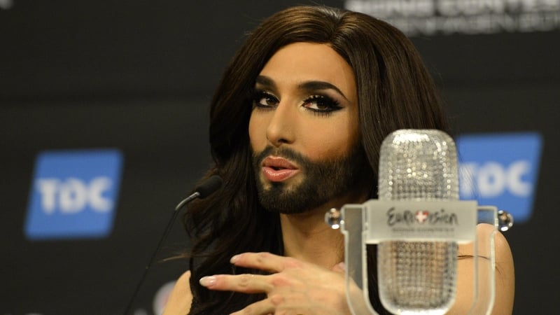 Conchita Wurst representing Austria poses with the trophy at a press conference after winning the Eurovision