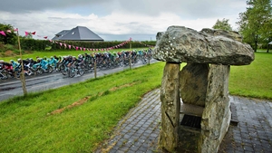 The Giro peloton passes by the Monasterboice dolmen on Sunday
