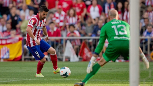 Malaga goalkeeper Willy Caballero frustrated David Villa and Atletico