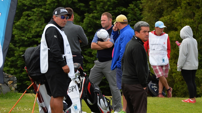 Alastair Forsyth of Scotland (centre), talks to fellow golfers after his caddie Ian McGregor tragically died