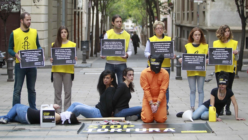 Members of Amnesty International take part in a 'Stop Torture' campaign rally in Barcelona, Spain