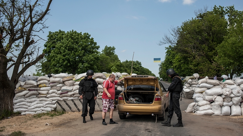 Ukrainian soldiers check a car at a checkpoint not far from Slaviansk, Ukraine