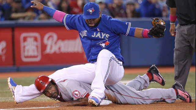 Toronto Blue Jays' Juan Francisco falls on Howie Kendrick of the Los Angeles Angels of Anaheim at Rogers Centre in Toronto
