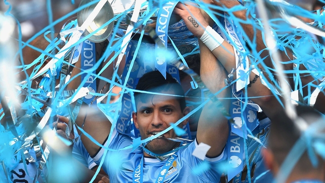 Sergio Aguero of Manchester City holds the Premier League trophy aloft